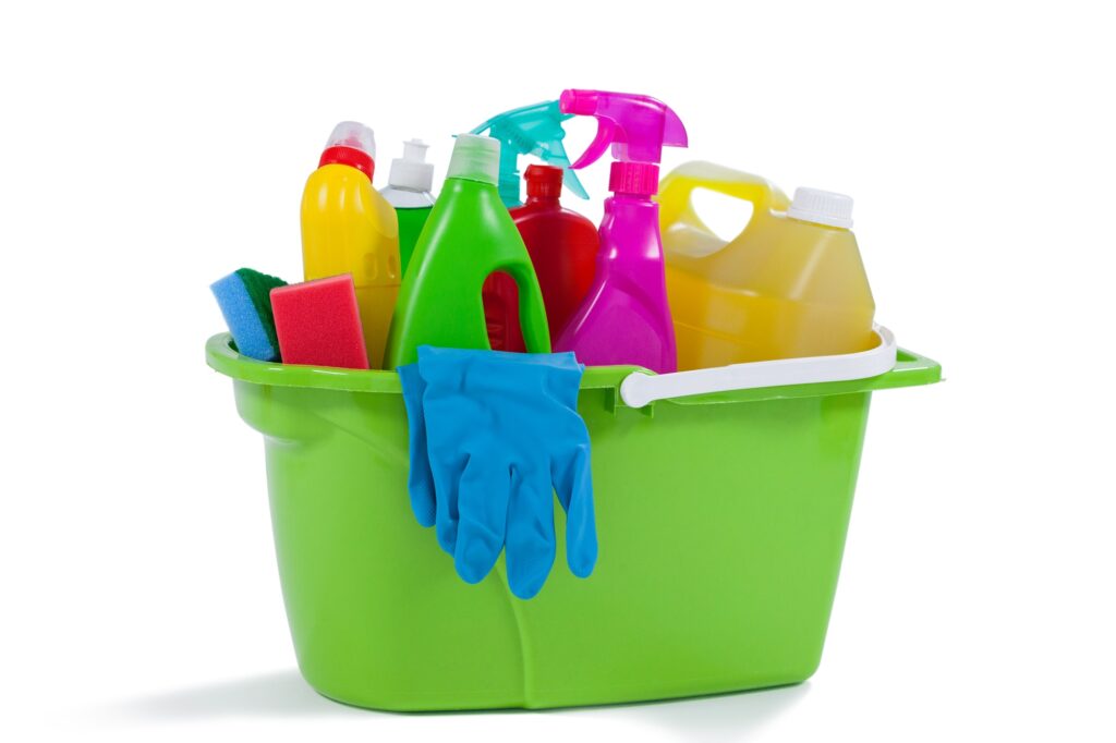 Various household cleaning supplies in a bucket