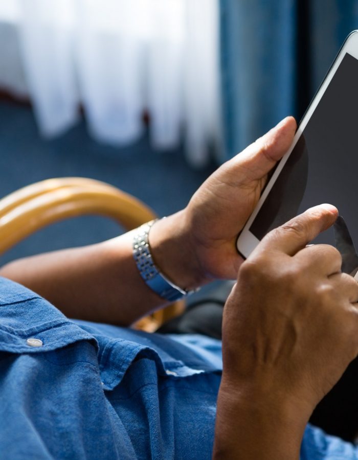 View of senior man using digital tablet at nursing home